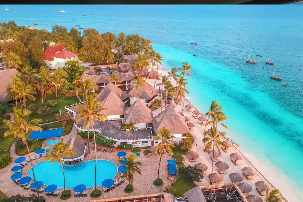 Aerial view of a beach resort and pool beside turquoise water on Zanzibar